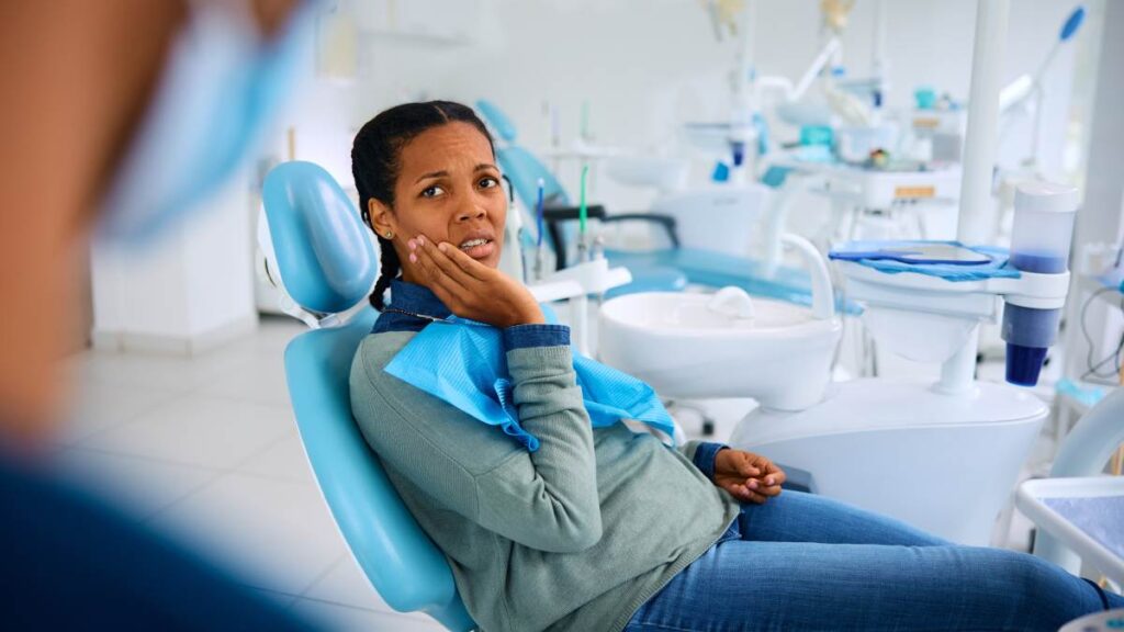 Hollywood smile risks and limitations: concerned patient in dental chair