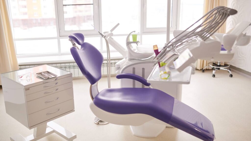 Modern dental clinic treatment room with chair and equipment, illustrating how to choose a clinic in Poland.