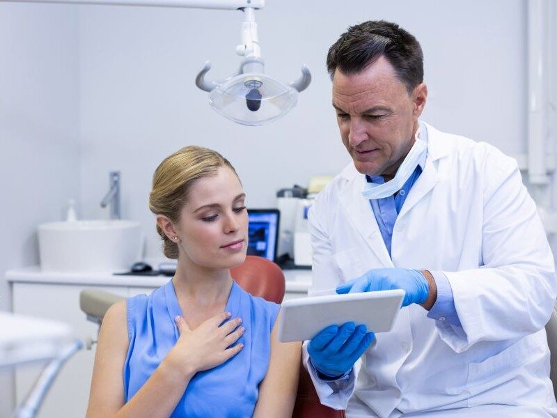 Dentist reviewing a treatment plan with a patient during a consultation in the dental clinic