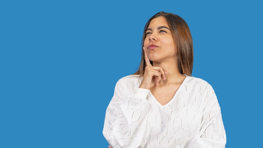 Woman thinking about veneers, crowns, or bonding for a smile makeover