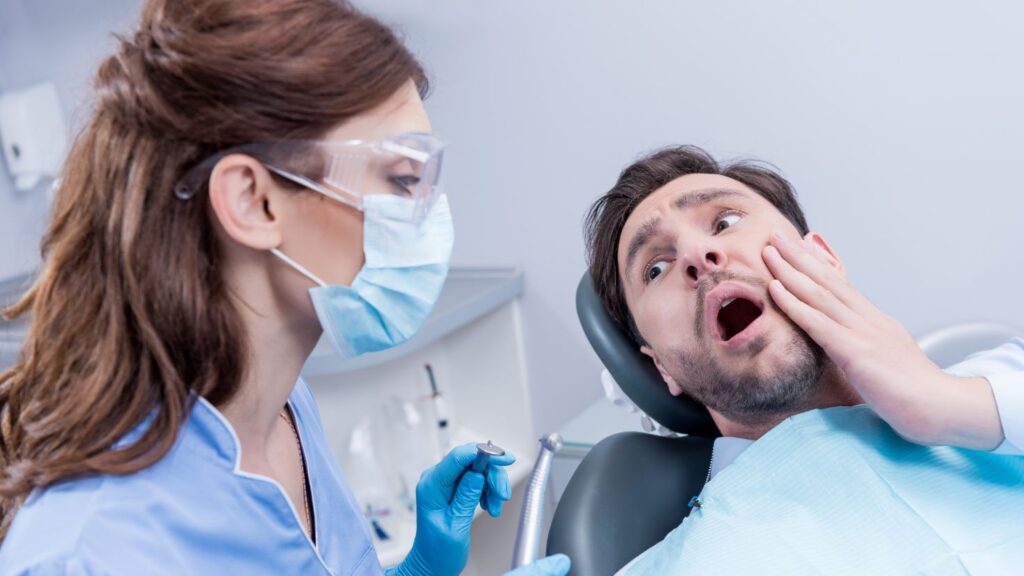 Is it an emergency if a veneer fell off? Dentist checking a worried patient