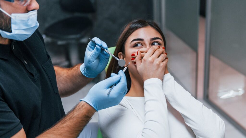 Dentist examining a patient after a veneer fell off