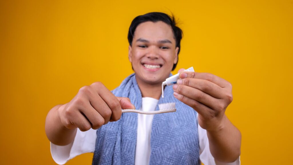 Man brushing teeth, tips to prevent a veneer from falling off again