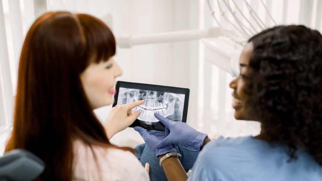 Bridal smile makeover consultation with dentist showing dental X-ray on a tablet